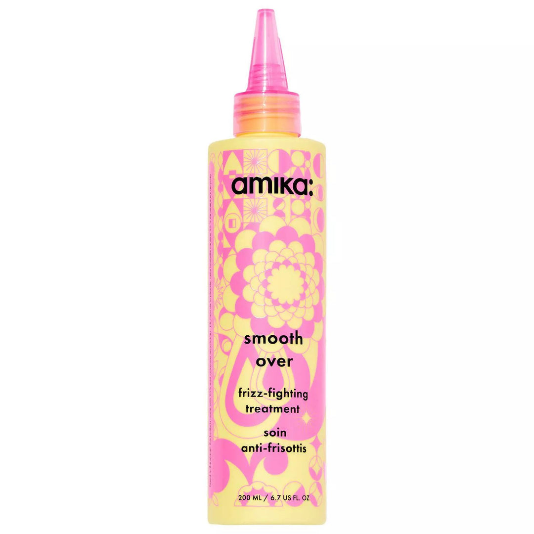 Amika Smooth Over Frizz-Fighting Treatment botella rosa amarilla.